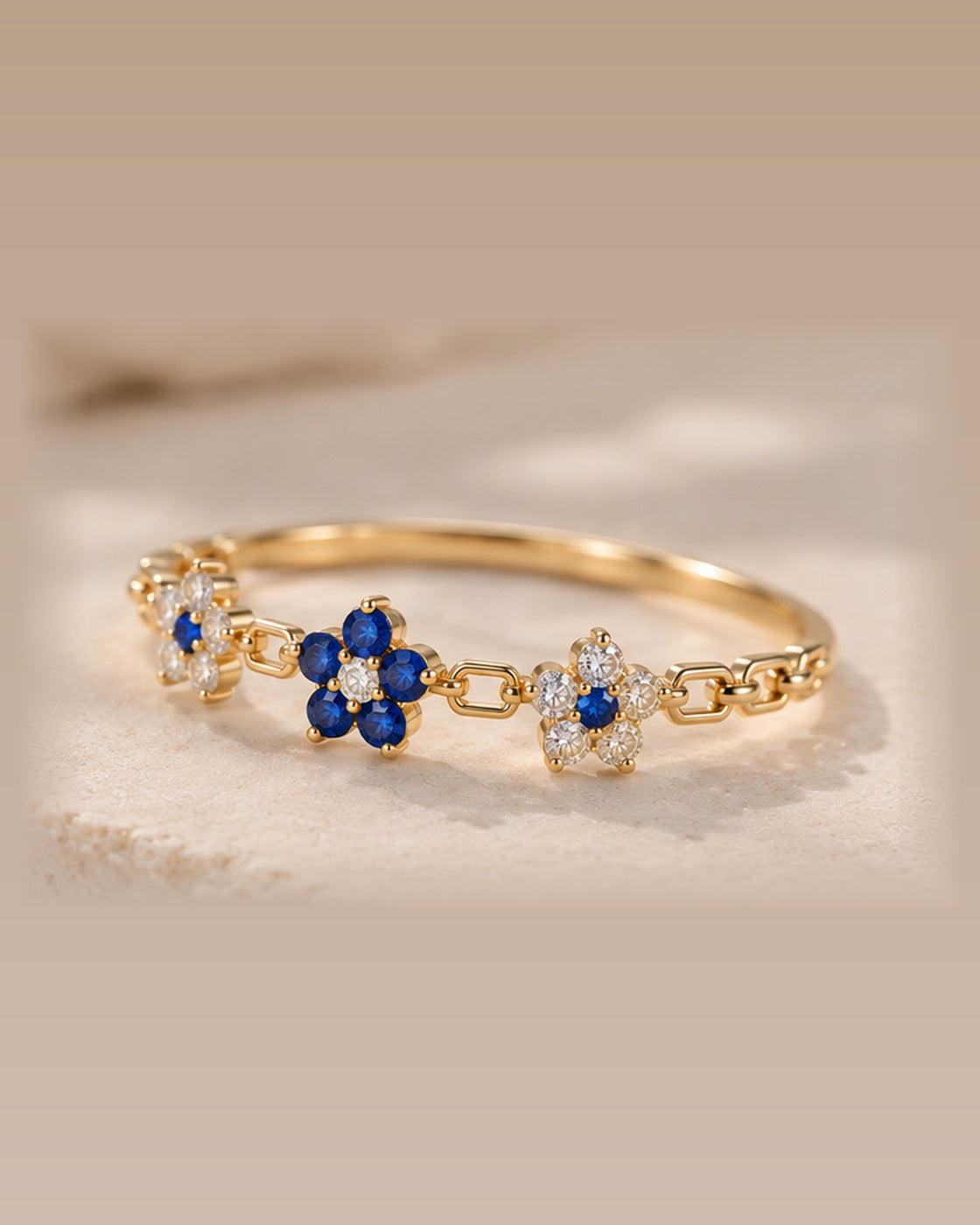 EVELYNNIE Floral Garland Ring with blue sapphires and natural diamonds in 18K yellow gold, three-quarter view