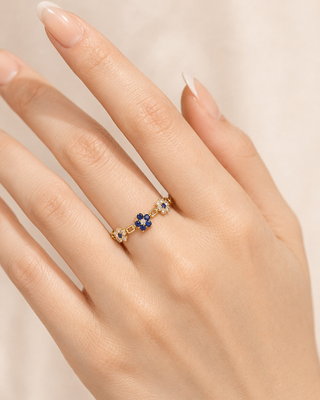 EVELYNNIE Floral Garland Ring with blue sapphires and natural diamonds worn on hand