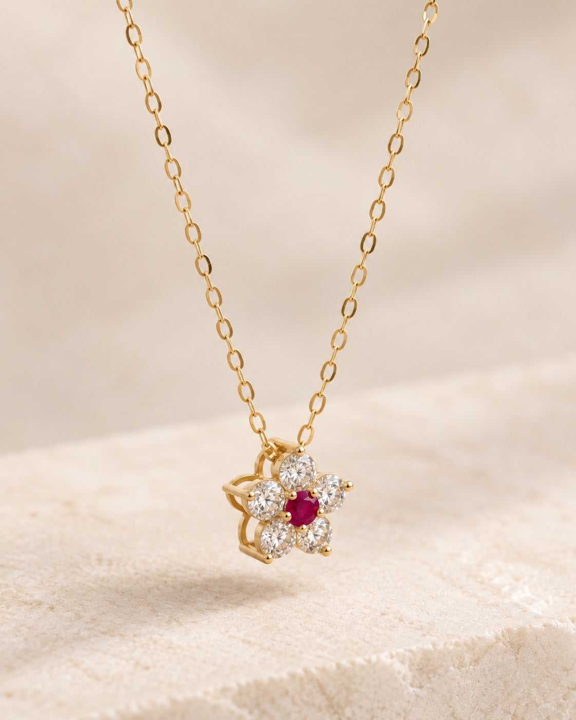 EVELYNNIE Floral Pendant Necklace in 18K yellow gold with ruby center and natural diamond petals, three-quarter view