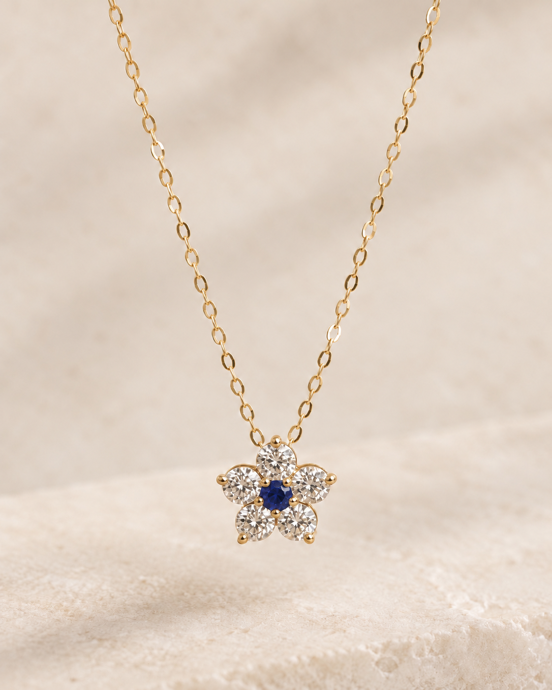 EVELYNNIE Floral Pendant Necklace in 18K yellow gold with blue sapphire center and natural diamond petals, front view