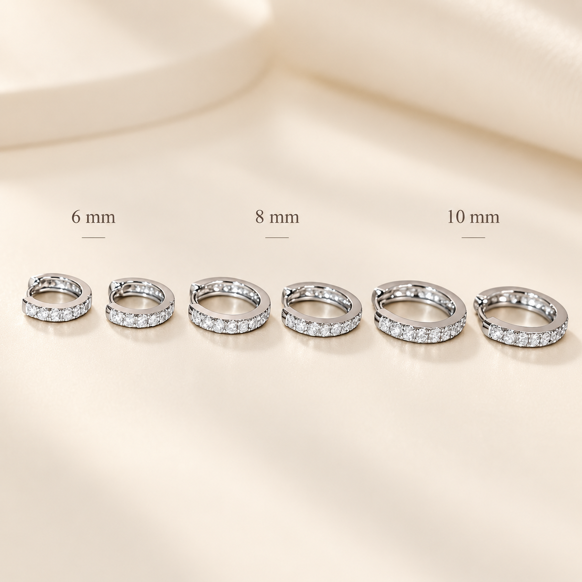 EVELYNNIE pavé huggie hoop earrings size guide showing 6 mm, 8 mm, and 10 mm inner diameters in white gold